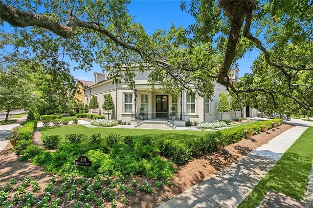 401 Northline St, Metairie, LA 70005 - view of front of house featuring stucco siding, a front yard, and covered porch