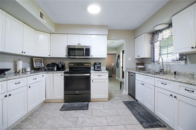 2172 Carmel Valley Dr, La Place, LA 70068 - kitchen with appliances with stainless steel finishes, visible vents, white cabinetry, and a sink