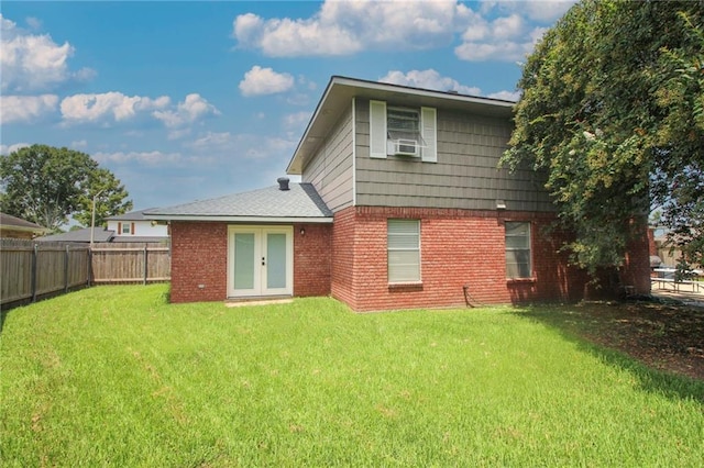 2172 Carmel Valley Dr, La Place, LA 70068 - back of property featuring a lawn, a fenced backyard, french doors, and brick siding