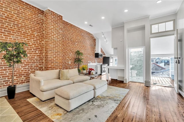 818 Bourbon St Unit 3A, New Orleans, LA 70116 - living area featuring brick wall, ornamental molding, hardwood / wood-style flooring, and recessed lighting