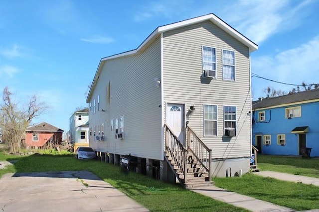 264749 Louisa St, New Orleans, LA 70117 - view of front facade featuring entry steps and a front yard