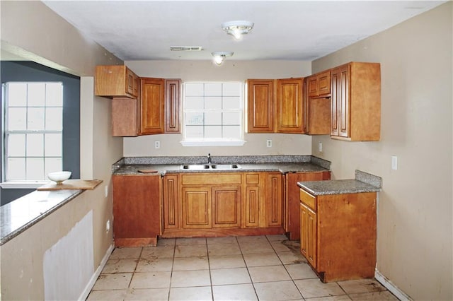 264749 Louisa St, New Orleans, LA 70117 - kitchen featuring baseboards, visible vents, a sink, and brown cabinets