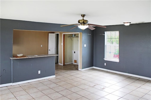 264749 Louisa St, New Orleans, LA 70117 - spare room with a ceiling fan, baseboards, and light tile patterned floors