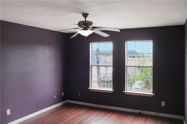 264749 Louisa St, New Orleans, LA 70117 - unfurnished room featuring wood finished floors, baseboards, and ceiling fan
