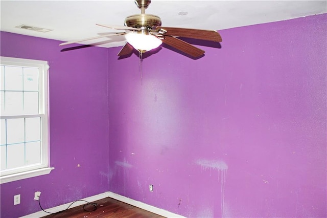 264749 Louisa St, New Orleans, LA 70117 - unfurnished room with dark wood finished floors, baseboards, a ceiling fan, and visible vents