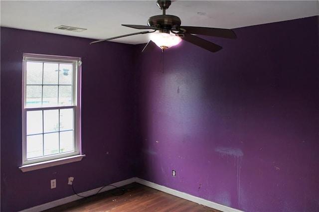 264749 Louisa St, New Orleans, LA 70117 - unfurnished room with wood finished floors, visible vents, a ceiling fan, and a wealth of natural light