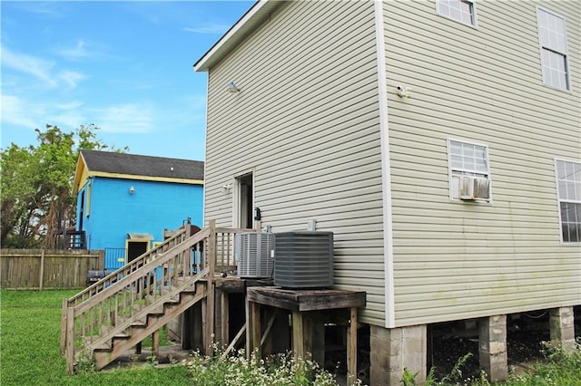 264749 Louisa St, New Orleans, LA 70117 - rear view of house with fence, a yard, and cooling unit