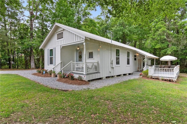 71463 Haynes St, Abita Springs, LA 70420 - exterior space featuring board and batten siding, a porch, and a front yard