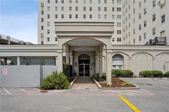 1205 St Charles Ave Unit 714, New Orleans, LA 70130 - property entrance featuring uncovered parking and stucco siding
