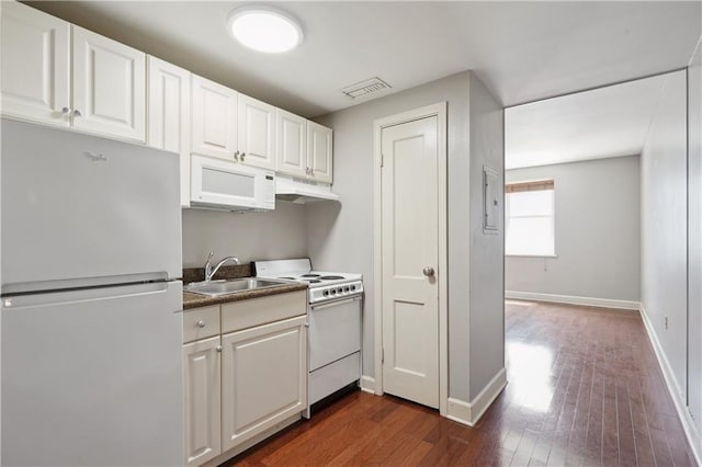 1205 St Charles Ave Unit 714, New Orleans, LA 70130 - kitchen with a sink, white appliances, white cabinetry, under cabinet range hood, and visible vents