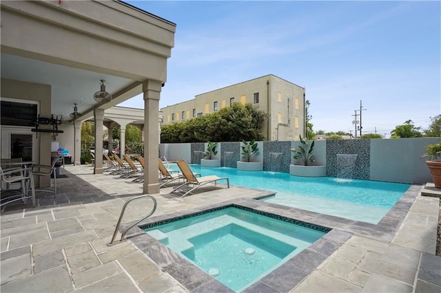 1205 St Charles Ave Unit 714, New Orleans, LA 70130 - view of swimming pool featuring fence, a patio area, a fenced in pool, and an in ground hot tub