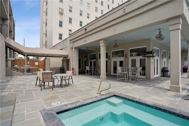 1205 St Charles Ave Unit 714, New Orleans, LA 70130 - view of pool featuring a patio area, french doors, and outdoor dining area