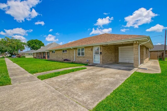 1021 Maplewood Dr, Harvey, LA 70058 - ranch-style house featuring a front lawn, an attached garage, concrete driveway, and brick siding
