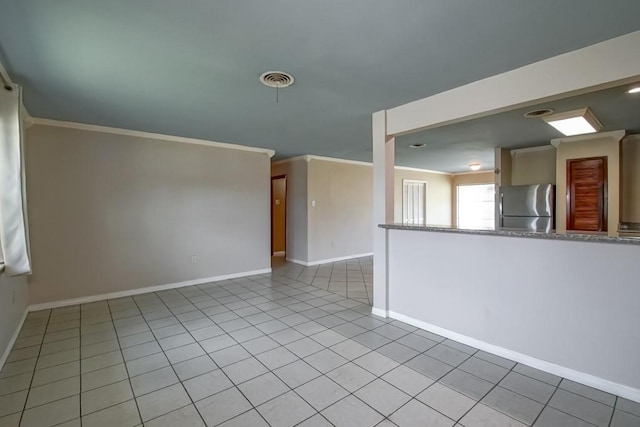 1021 Maplewood Dr, Harvey, LA 70058 - unfurnished living room with light tile patterned flooring, ornamental molding, and baseboards