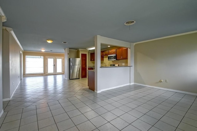 1021 Maplewood Dr, Harvey, LA 70058 - unfurnished living room featuring ornamental molding, light tile patterned flooring, visible vents, and baseboards