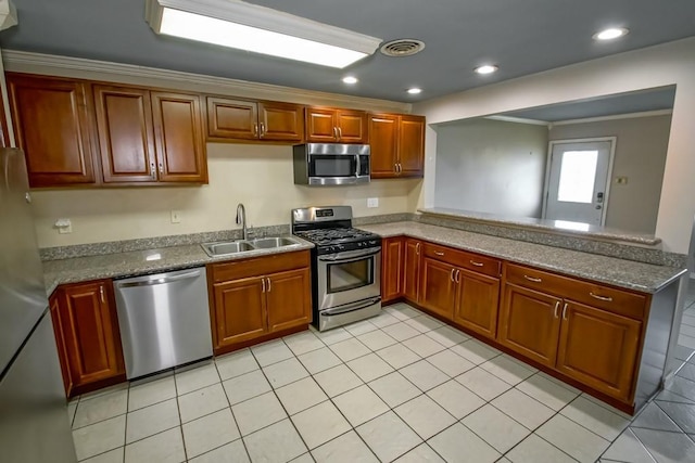 1021 Maplewood Dr, Harvey, LA 70058 - kitchen featuring brown cabinets, a sink, stainless steel appliances, a peninsula, and ornamental molding