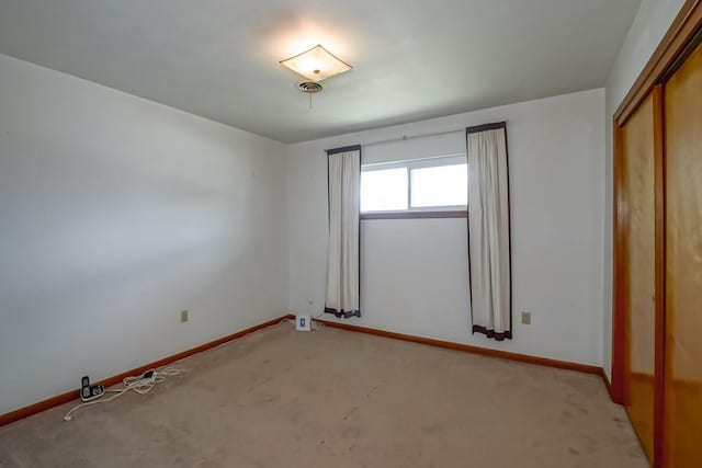 1021 Maplewood Dr, Harvey, LA 70058 - unfurnished bedroom featuring a closet, light colored carpet, and baseboards