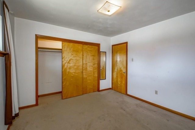 1021 Maplewood Dr, Harvey, LA 70058 - unfurnished bedroom with baseboards, a closet, and light colored carpet