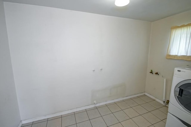 1021 Maplewood Dr, Harvey, LA 70058 - laundry room with baseboards, light tile patterned floors, washer / dryer, and laundry area
