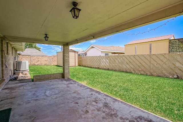 1021 Maplewood Dr, Harvey, LA 70058 - view of patio / terrace featuring a storage shed, central AC unit, an outdoor structure, and a fenced backyard