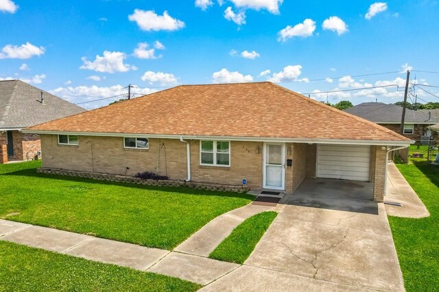 1021 Maplewood Dr, Harvey, LA 70058 - ranch-style home featuring roof with shingles, a front lawn, concrete driveway, and an attached garage