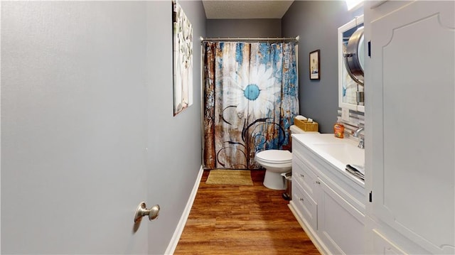 31763 Shelton Dr, Springfield, LA 70462 - full bathroom featuring toilet, baseboards, wood finished floors, curtained shower, and vanity