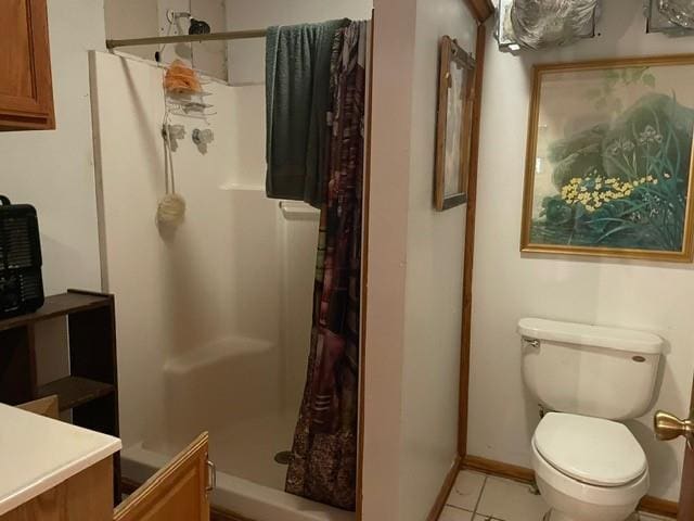 46038 Wooding Ln, Franklinton, LA 70438 - full bath with a stall shower, toilet, tile patterned flooring, vanity, and baseboards