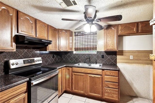 716 N Woodlawn Ave, Metairie, LA 70001 - kitchen featuring electric stove, under cabinet range hood, a sink, ceiling fan, and dark countertops