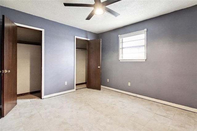 716 N Woodlawn Ave, Metairie, LA 70001 - unfurnished bedroom with multiple closets, a textured ceiling, baseboards, and a ceiling fan