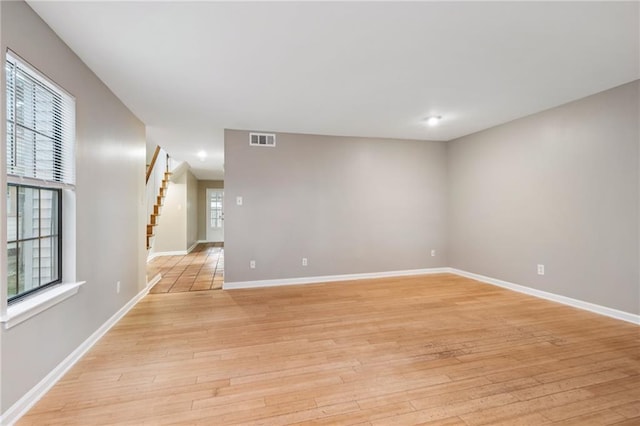 4738 Banks St, New Orleans, LA 70119 - unfurnished room with light wood-style flooring, baseboards, and stairs