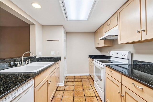 4738 Banks St, New Orleans, LA 70119 - kitchen featuring white appliances, under cabinet range hood, light brown cabinetry, and dark stone counters