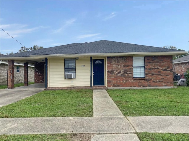 single story home with brick siding, a front lawn, roof with shingles, and concrete driveway
