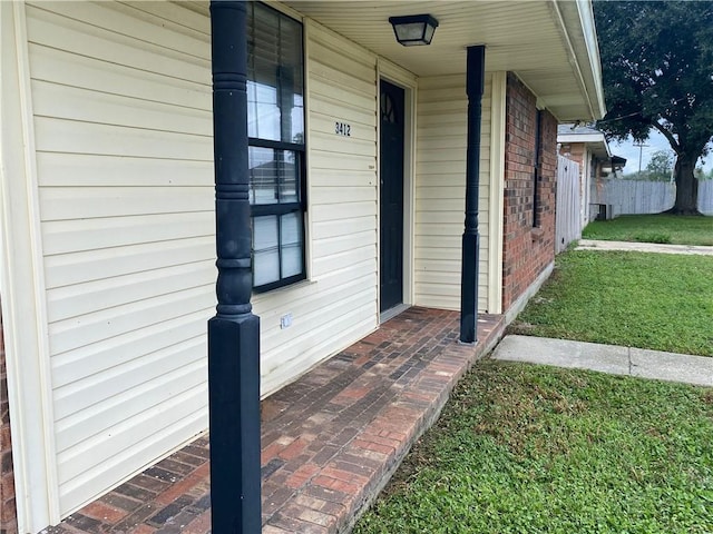 view of exterior entry with brick siding
