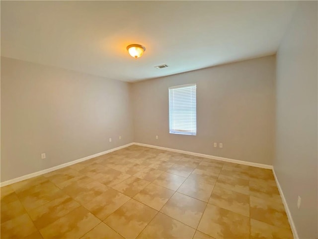 unfurnished room with visible vents, baseboards, and light tile patterned floors