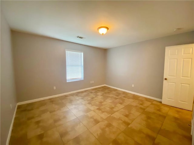 spare room with visible vents, baseboards, and light tile patterned flooring