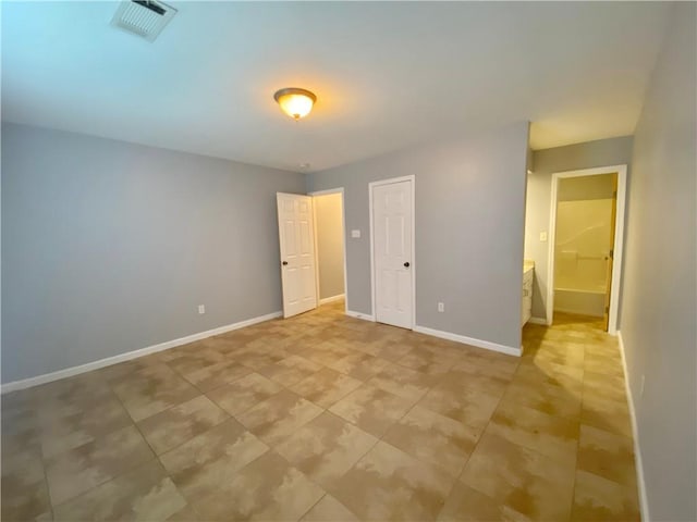 unfurnished bedroom with baseboards, light tile patterned flooring, and visible vents
