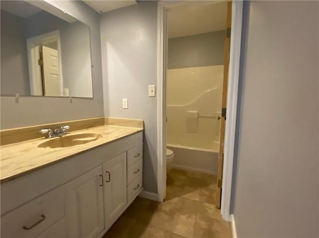 bathroom featuring vanity, tile patterned floors, toilet, and bathing tub / shower combination