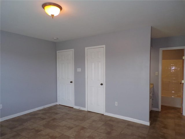 unfurnished bedroom with baseboards and a closet