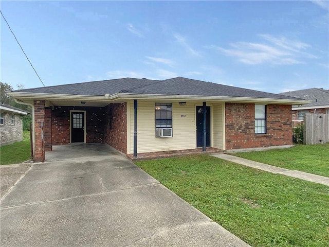 ranch-style house featuring fence, concrete driveway, brick siding, and a front yard