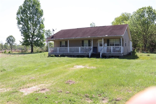 view of front facade with a front yard and covered porch