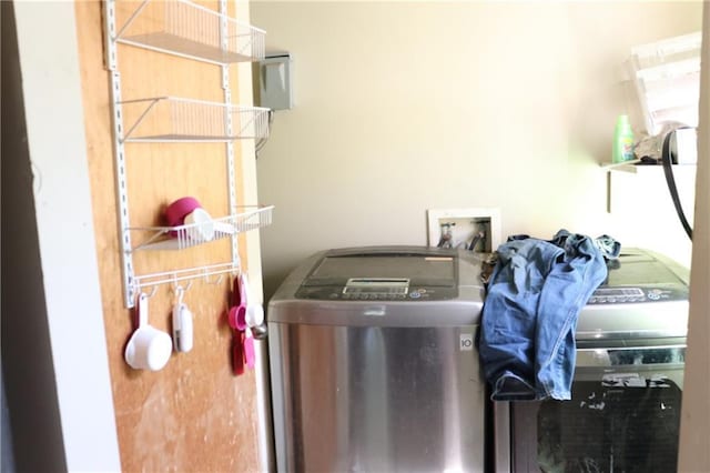 washroom with washing machine and clothes dryer and laundry area