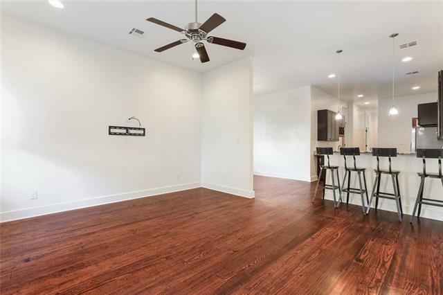 842 Toledano St, New Orleans, LA 70115 - empty room featuring baseboards, a ceiling fan, visible vents, and dark wood-style floors