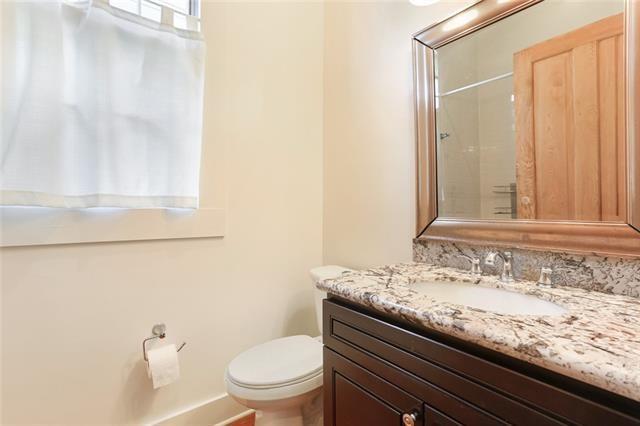 842 Toledano St, New Orleans, LA 70115 - bathroom with toilet, vanity, and baseboards