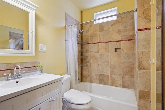 full bath with shower / tub combo with curtain, toilet, and vanity