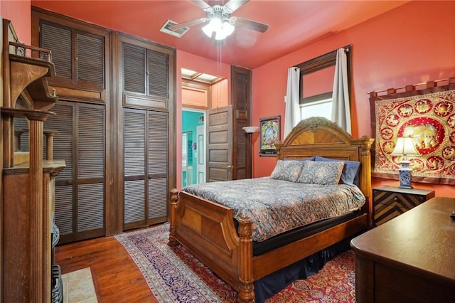 bedroom featuring a ceiling fan, wood finished floors, and visible vents