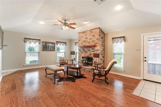 4740 W Esplanade Ave, Metairie, LA 70006 - living area with wood finished floors, visible vents, a fireplace, and a ceiling fan