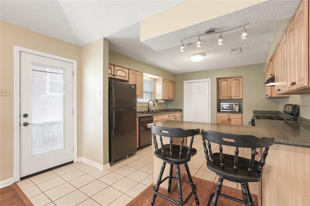 4740 W Esplanade Ave, Metairie, LA 70006 - kitchen featuring dark countertops, a sink, black appliances, a peninsula, and a textured ceiling