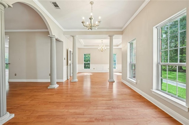 4761 Sharp Rd, Mandeville, LA 70471 - entryway featuring a chandelier, decorative columns, healthy amount of natural light, crown molding, and light wood-type flooring