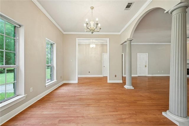 4761 Sharp Rd, Mandeville, LA 70471 - entrance foyer with ornate columns, plenty of natural light, light wood-type flooring, and ornamental molding
