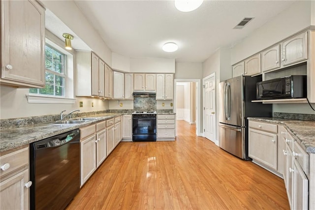 4761 Sharp Rd, Mandeville, LA 70471 - kitchen featuring black appliances, light wood finished floors, and under cabinet range hood